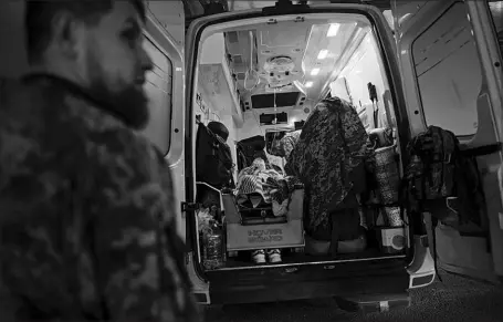  ?? LYNSEY ADDARIO / THE NEW YORK TIMES ?? An injured Ukrainian soldier is brought into a city hospital Monday as explosions thunder nearby in Kramatorsk, Ukraine. Fighting intensifie­d in the Donbas region as May 9, the date when Russians and Ukrainians celebrate the end of World War II, neared.