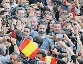  ?? Manuel Bruque EPA/Shuttersto­ck ?? SANTIAGO ABASCAL, the leader of Vox, waves at an event Thursday in Valencia, Spain. National unity and identity questions have defined the general election.