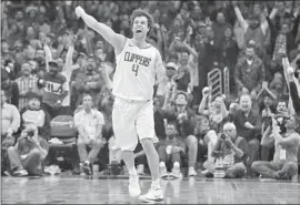  ?? Jae C. Hong Associated Press ?? MILOS TEODOSIC, who returned from a foot injury, celebrates a three-point basket during the second half of the Clippers’ 96-91 victory over Toronto.