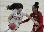  ?? MORRY GASH — THE ASSOCIATED PRESS ?? Stanford’s Haley Jones tries to drive past Louisville’s Kianna Smith during the first half of an Elite Eight matchup on Tuesday at the Alamodome in San Antonio.