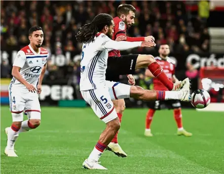  ??  ?? Eyes on the ball: Guingamp midfielder Nicolas Benezet (right) vying for the ball with Lyon defender Jason Denayer during the Ligue 1 match at the Le Roudourou Stadium on Saturday. — AFP