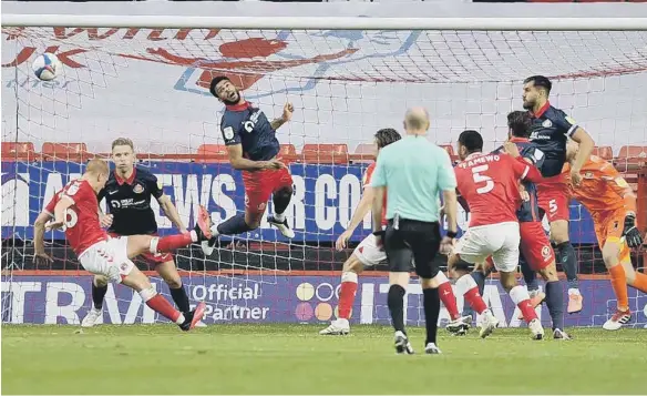  ??  ?? This late header from Jordan Willis drew special praise from manager Phil Parkinson