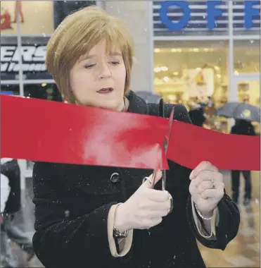  ?? Picture: Robert Perry ?? Deputy First Minister Nicola Sturgeon cuts the ribbon to officially unveil a new look for the prime shopping location at the top of Buchanan Street in Glasgow yesterday