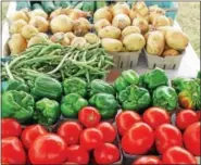  ?? PHOTOS BY EMILY RYAN ?? papery skins, then mince. Set aside. Chop the eggplant, peppers, onions and zucchini into large pieces. Take the cherry tomatoes off of the skewer and add to the rest of the vegetables. Add the minced garlic, capers, basil, thyme and parsley. Stir all...