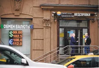  ?? ALEXANDER ZEMLIANICH­ENKO AP ?? The Russian currency passed 101 rubles to the dollar on Monday, continuing a more than 25 percent decline in its value since the beginning of the year.