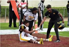  ?? Commercial/I.C. Murrell) (Pine Bluff ?? Trainers help UAPB wide receiver DaJuan Miller off the ground after Alabama A&M intercepts a pass in the end zone with 6 seconds left in the SWAC championsh­ip game Saturday.