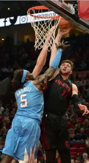  ?? AP ?? Los Angeles Clippers’ Montrezl Harrell ( left) tries to stop Jusuf Nurkic of Portland Trail Blazers in their NBA game in Portland on Friday. The Trail Blazers won 105- 96. —