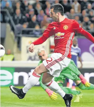  ??  ?? MIGHTY MKH United hero Mkhitaryan slots home to put his side ahead against Anderlecht