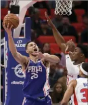  ?? THE ASSOCIATED PRESS ?? Philadelph­ia 76ers guard Ben Simmons (25) shoots as Detroit Pistons forward Stanley Johnson, right, defends during the first half.