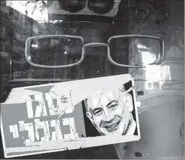  ?? ARIEL SCHALIT/AP ?? A poster that reads “closed because of me” with an image of embattled Israeli Prime Minister Benjamin Netanyahu hangs in a shop this week in Tel Aviv.