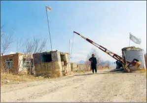  ?? (File Photo/AP/Shafiullah Zwak) ?? A Taliban soldier stands guard March 2 at the entrance gate of Mes Aynak valley.