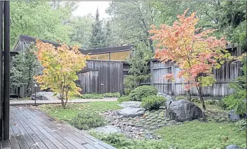  ?? ROBERT C. MUSCHEWSKE/ SUMMIT IMAGES, LLC VIA AP ?? A garden around a single family home in St. Paul, Minnesota. The courtyard shows the entry courtyard, where the landscape suggests an alpine meadow with a meandering stream. The garden in this image was designed and constructe­d by David Slawson. It was later restored and expanded by John Powell, of Zoen, LLC.