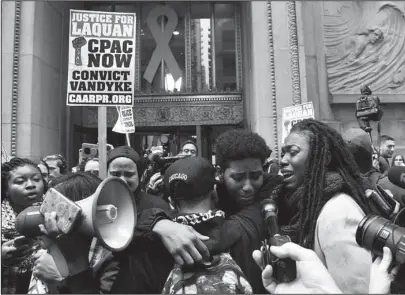  ?? The Associated Press ?? VERDICT REACHED: People react outside of City Hall after a jury convicted white Chicago police Officer Jason Van Dyke of second-degree murder in the 2014 shooting of black teenager Laquan McDonald on Friday in Chicago. Van Dyke, 40, was the first Chicago officer to be charged with murder for an on-duty shooting in about 50 years. He was taken into custody moments after the verdict was read.