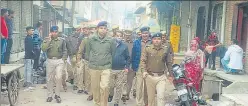  ?? HT PHOTO ?? SSP Mathura Dr Gaurav Grover leads a police march through lanes and market of Mathura city .