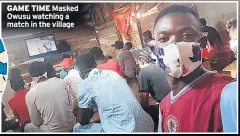  ??  ?? GAME TIME Masked Owusu watching a match in the village