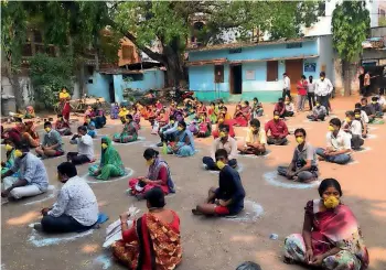  ?? ANI ?? MAINTAININ­G SOCIAL DISTANCE: People maintain social distance as they wait for their turn to receive relief during the lockdown in Hyderabad on Sunday. —