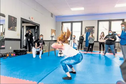  ?? PHOTOS COURTESY LYNN QUINLIVAN ?? Katy Kellett completed 76 jump squats in a minute, which is expected to be recognized by the Guinness World Records in the coming weeks. She was cheered on by her family and friends at Driven Fit in Groton. Below, she is all smiles after her feat.