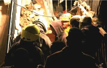  ??  ?? Rescue workers search for survivors in the ruins of a building that collapsed in Huruma, Kenya. — Reuters photo