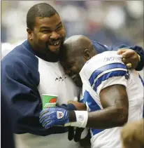  ?? Tribune News Service ?? Dallas Cowboys offensive lineman Larry Allen, left, hugs running back Emmitt Smith after he broke the NFL all-time career rushing record against the Seattle Seahawks at Texas Stadium in 2002.