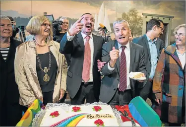  ?? Picture: AFP ?? LONG-AWAITED CELEBRATIO­NS: Karl Kreile, centre left, and Bodo Mende, centre right, after cutting their rainbow wedding cake during their wedding ceremony yesterday