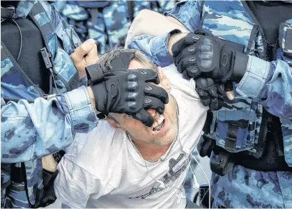  ?? SHAMIL ZHUMATOV • REUTERS ?? Law enforcemen­t officers detain a participan­t of a rally calling for opposition candidates to be registered for elections to Moscow City Duma, the capital's regional parliament, Saturday in Moscow.