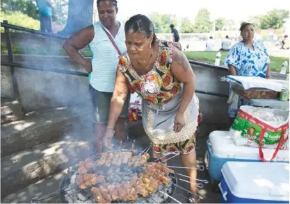  ?? PHOTOS BY YOON S. BYUN/GLOBE STAFF ?? Yolanda Rodrigues has been serving up her grilled fare at Ceylon Park on summer weekends for more than a decade.