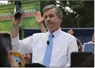  ?? (AP/Hannah Schoenbaum) ?? North Carolina Democratic Gov. Roy Cooper affixes his veto stamp to a bill banning nearly all abortions after 12 weeks of pregnancy at a public rally May 13 in Raleigh, N.C.