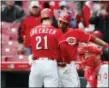  ?? JOHN MINCHILLO — THE ASSOCIATED PRESS ?? Cincinnati Reds’ Michael Lorenzen (21) celebrates with Billy Hamilton, center, after hitting a solo home run off Philadelph­ia Phillies relief pitcher Adam Morgan Thursday in Cincinnati.