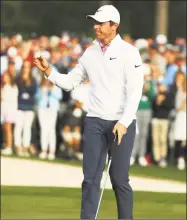 ?? Andrew Redington / Getty Images ?? Rory McIlroy waves tp the crowd on the 18th green during the final round of the Masters Sunday in Augusta, Ga.