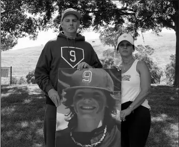  ?? GODOFREDO A. VÁSQUEZ / ASSOCIATED PRESS PHOTO ?? Padrig and Gina Fahey hold a photo of their son, Braden, 12, on Sept. 6 in California. Braden collapsed at football practice in August 2022 and died of a malformed blood vessel in the brain. The Faheys couldn’t understand how Braden’s face appeared on the cover of the book “Cause Unknown,” which was co-published by an anti-vaccine group led by Robert F. Kennedy Jr., or why his name appeared inside it.