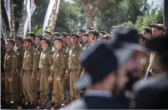  ?? (Noam Moskowitz/Flash90) ?? RELIGIOUS SOLDIERS attend a swearing-in ceremony as they enter the IDF’s Nahal Haredi unit. Hayut has delayed ruling on the issue of haredim integratin­g into the IDF.