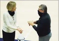  ?? David Butler II / Associated Press ?? UConn head coach Geno Auriemma and associate head coach Chris Dailey sanitize their hands before a Jan. 9 game against Providence.