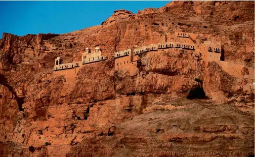  ??  ?? ABOVE: The Quarantia today, with the Greek Orthodox Christian Monastery of the Temptation near Jericho. The monastery was built during the sixth century above the cave traditiona­lly said to be the place where Jesus spent 40 days and nights fasting and meditating before the Temptation­s.