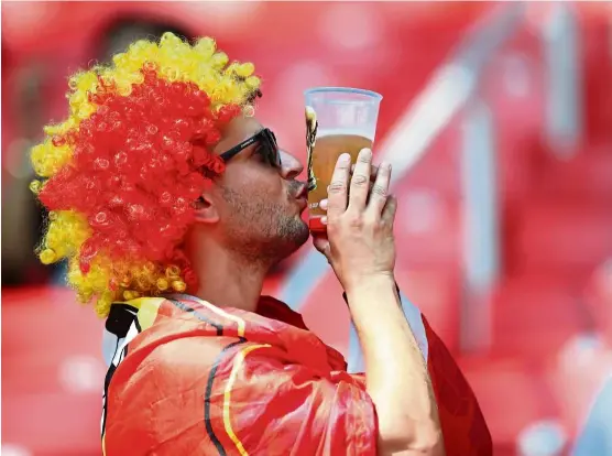  ?? — Reuters ?? A Belgium fan kissing his beer before a football match. Although beer sales in Russia have gone up during the World Cup, the trend is not expected to last beyond the event.