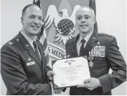  ?? [PHOTO PROVIDED] ?? Oklahoma graduate and Air Force Lt. Col. Steven Fisher, right, received his Purple Heart from Col. Douglas Curry in a 2016 ceremony at Scott Air Force Base.