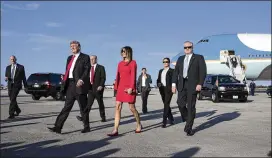  ?? STEPHEN CROWLEY / THE NEW YORK TIMES ?? President Donald Trump meets his wife, Melania, after arriving in West Palm Beach on Feb. 3. Secret Service agents from across the country are being temporaril­y pulled off criminal investigat­ions to protect the Trump family.