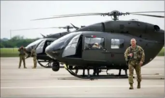  ?? AMANDA VOISARD/AUSTIN AMERICAN-STATESMAN VIA AP ?? Two UH-72 Lakota helicopter­s are prepared for takeoff at the Armed Forces Reserve Center at Austin-Bergstrom Internatio­nal Airport, Friday, April 6, 2018, in Austin, Texas. Their mission is part of an order signed by U.S. President Donald Trump earlier...