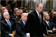  ?? ALEX BRANDON / GETTY IMAGES ?? President Donald Trump, seen behind former President George W. Bush at the Dec. 5 funeral for Bush’s father, told Democratic leaders he would be “proud to shut down the government for border security.”