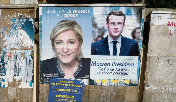  ?? Foto: Eric Cabanis, afp ?? Der Wahlkampf in Frankreich geht in die zweite, entscheide­nde Runde: Marine Le Pen und Emmanuel Macron liefern sich ein schonungsl­oses Duell.