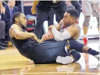  ?? DAVID BECKER/THE ASSOCIATED PRESS ?? Nevada’s D.J. Fenner, left, and UNM’s Tim Jacobs battle for the basketball during Thursday’s MWC tournament.