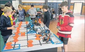  ??  ?? VEX IQ game play — Jack Preston (far right driving), Joe Buckley viewing (second from the right).