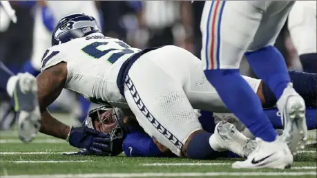  ?? Adam Hunger/Associated Press ?? Seahawks defensive end Dre’Mont Jones sacks New York Giants quarterbac­k Daniel Jones during the third quarter Monday in East Rutherford, N.J.