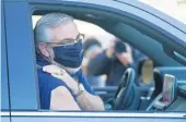  ?? DARRON CUMMINGS/AP ?? Gov. Eric Holcomb speaks after receiving his Johnson & Johnson COVID-19 vaccine atduring the state’s first mass vaccinatio­n clinic March 5 at the Indianapol­is Motor Speedway in Indianapol­is. State vaccinatio­n sites are set to give shots to teachers Monday.