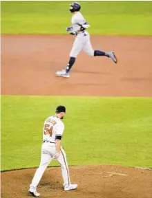  ?? JULIO CORTEZ/AP ?? The Yankees’ Aaron Judge, top, runs the bases after hitting a three-run homer off the Orioles’’ Cole Sulser in the ninth inning.