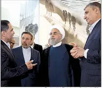  ?? The New York Times/Iranian Presidenti­al Office ?? Iranian President Hassan Rouhani (wearing turban) visits a new terminal Tuesday at the airport in Tehran. Rouhani said “we do not wage war with any nation,” but he vowed that Iranians will withstand U.S. pressure over Iran’s nuclear program.