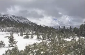  ?? Anna Johnson / Associated Press ?? A uniquely early snow hit the Sierra on the last full day of summer, blanketing Yosemite near Tioga Pass and causing a fatal car pileup on Interstate 80.