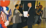  ??  ?? Eva Turner Elementary School Vice Principal Jason Deihl presents U.S. Air Force veteran Carole Cypress with a certificat­e during the school’s Veterans Day program Friday.