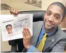  ?? ALGERINA PERNA/BALTIMORE SUN ?? City Councilman Brandon Scott holds a municipal ID card his legislatio­n is introducin­g. A final vote on the documents is scheduled for next week.