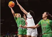  ?? Icon Sportswire via Getty Images ?? Notre Dame’s Hannah Hidalgo, left, goes up for a basket in the Irish’s win over Virginia Tech.
