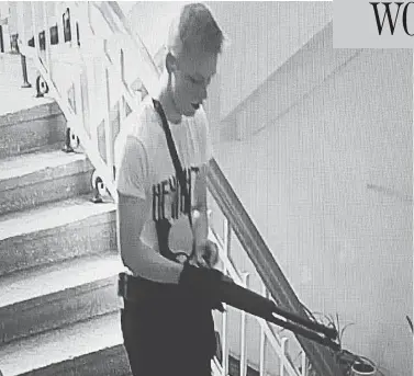  ?? CCTV FOOTAGE ?? A CCTV image appears to show student Vladislav Roslyakov, 18, stalking the halls of Kerch Polytechni­c College.